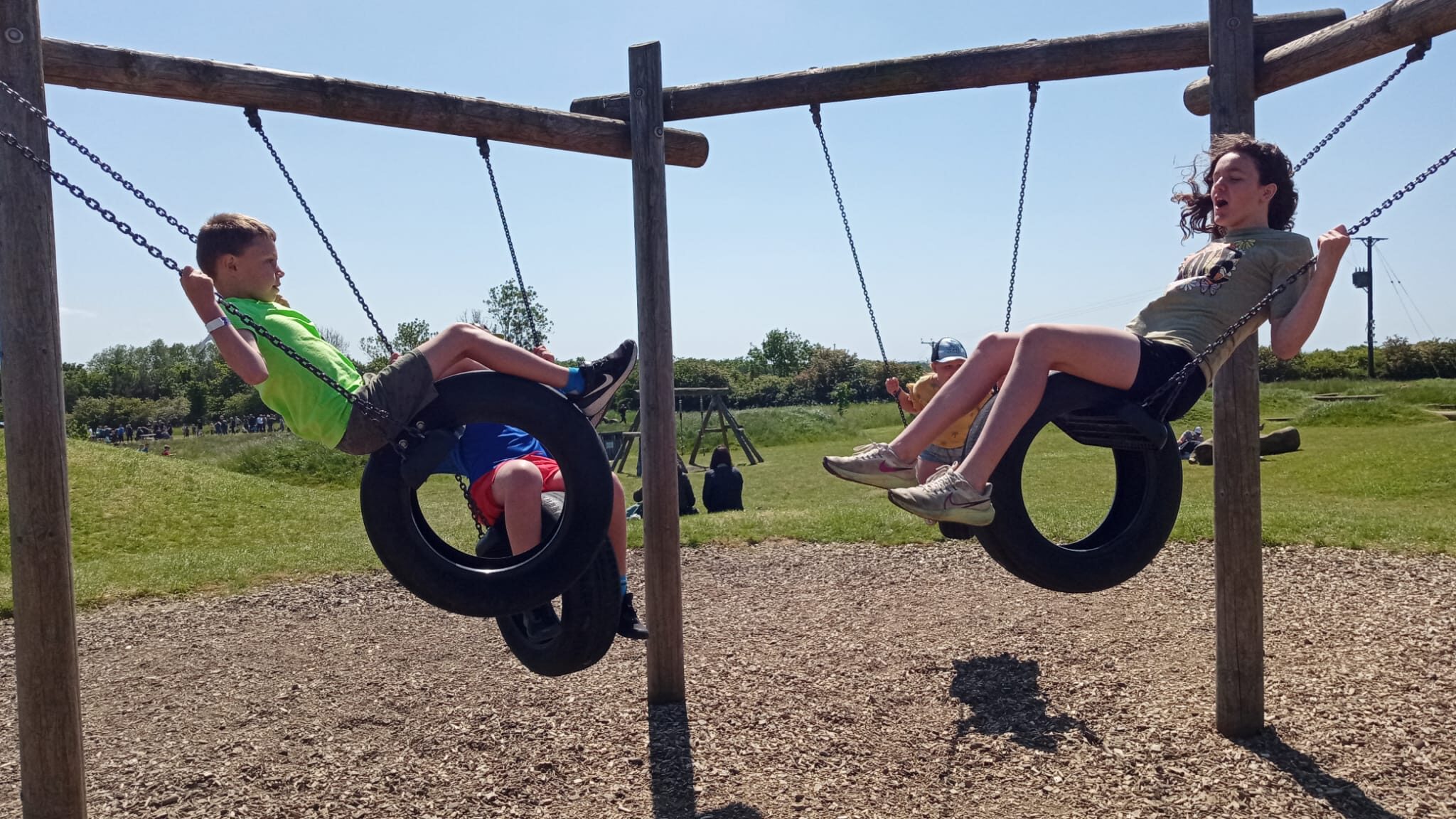 kids playing on swings at williams den