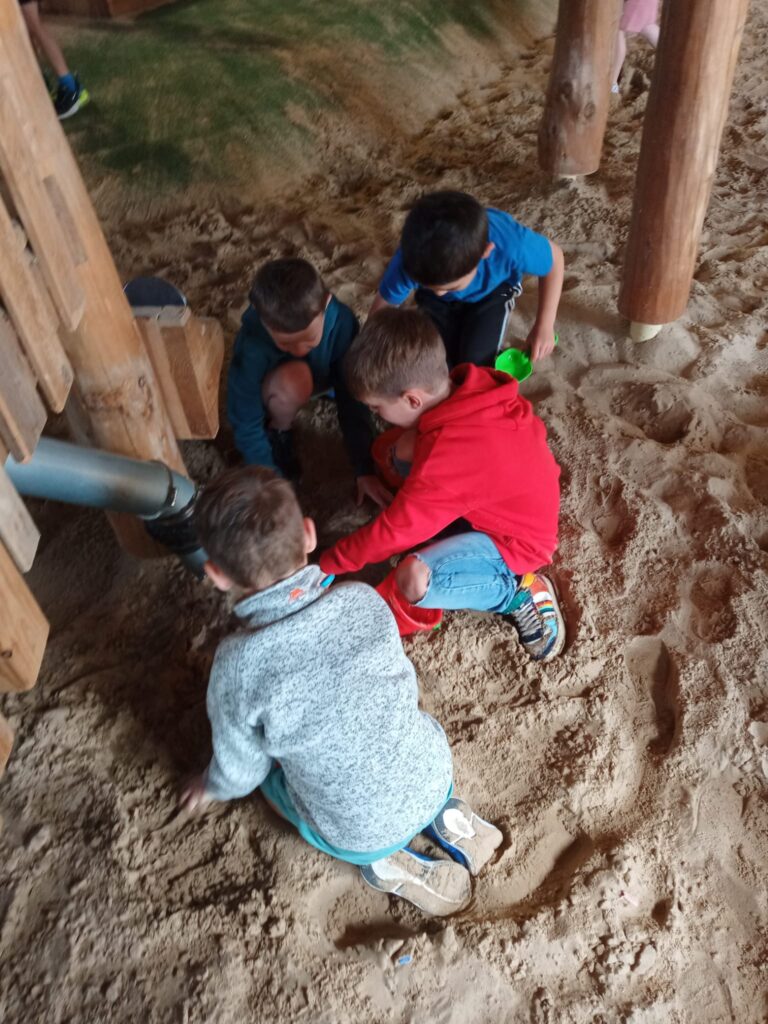 Group of boys playing in the sand at William Den